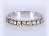a close up of a diamond ring on a white surface