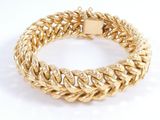 a close up of a gold bracelet on a white background