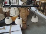 a room with a lot of lamps and pictures on the wall