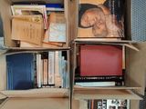boxes of books are stacked on top of each other in a room