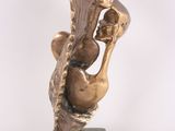 bronze sculpture of a woman holding a bird on a marble base
