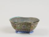 a close up of a small bowl on a white surface