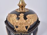 a black and gold helmet with a gold eagle on it