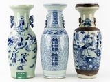 three blue and white vases sitting next to each other on a white surface