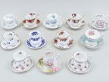 a lot of tea cups and saucers sitting on a table