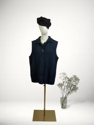 the mannequin is wearing a black shirt and a black hat