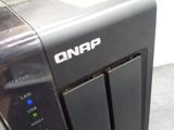 a hand that is holding a small device on a table