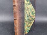 a close up of a book with a green and brown cover