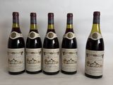 six bottles of wine are lined up in a row on a table