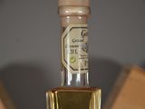 a bottle of olive oil sitting on top of a table