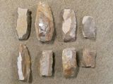 several pieces of rock sitting on top of a carpet next to a pair of scissors