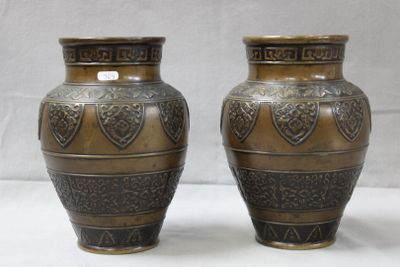 two vases sitting side by side on a white surface