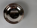 a silver plate on a white surface with a black object