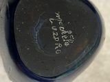 a close up of a black vase with writing on it
