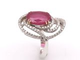 a close up of a pink stone and diamond ring on a white background