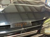 a close up of a black car with a sticker on it