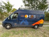a blue van that is parked in the grass