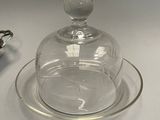 a glass plate with a glass dome on top of it