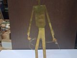 a metal sculpture of a man with a hat on