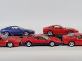 several toy cars are lined up in a row on a white surface