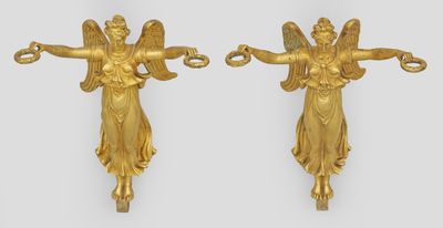 pair of antique gold angel wall sconces on a white background