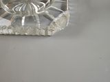 a glass bowl sitting on top of a coaster on a table