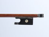 a violin bow that is attached to a piece of wood