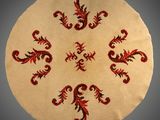 une image représentant un tapis rond orné de motifs rouges et noirs