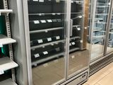 many empty shelves in a store that are full of items