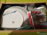 a box with a white plate and a cup in it
