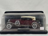 a model of an old car in a glass case