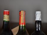 three bottles of wine sitting on a wooden table