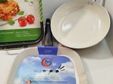 two pans and a pan of food on the counter