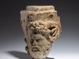 a close up of a sculpture of a head with a face on it