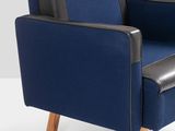 the blue chair is next to a black ottoman on a white surface
