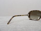 sunglasses on a white surface with a white wall in the background