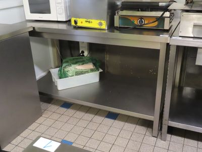 a microwave and a toaster sitting on a stainless steel counter