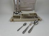 a silverware set in a case with spoons and spoons