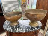 two bowls sitting on top of a table in a room