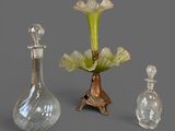 three glass vases with flowers in them on a table
