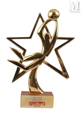 gold trophy with a woman holding a star on top of it