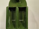 a green container that has two glasses inside of it
