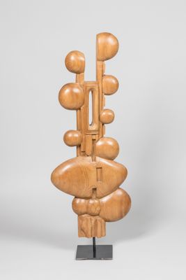 une photo d'une sculpture en bois posée sur un socle métallique