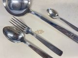 three spoons and two spoons sitting on a counter