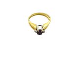 an image of a gold ring with a black stone in the middle