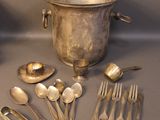 a lot of silver spoons and spoons on the table