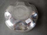a silver bowl with a tag on it on a table