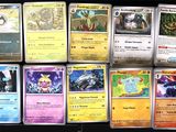 pokemon cards are lined up in a row on a table