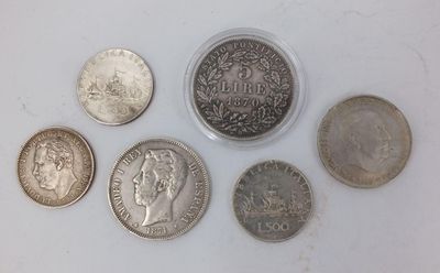 six different types of coins on a white surface