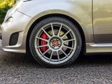a close up of a car ' s wheels and rims on the road